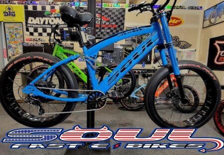 A blue bicycle parked in front of a building.