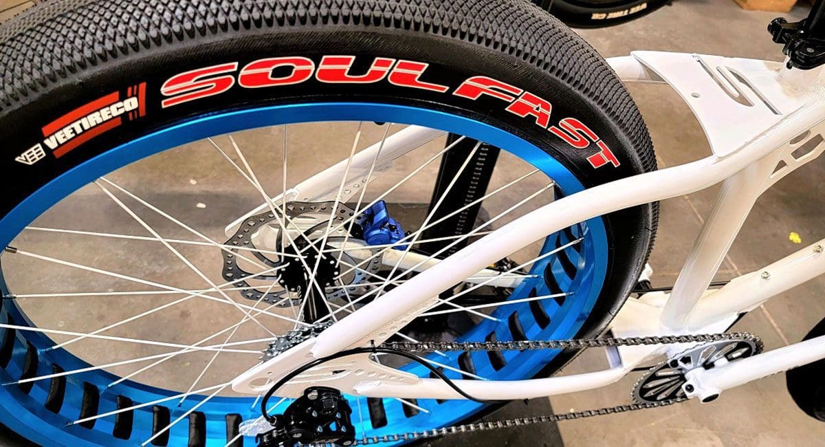 A Pedal Stomper bicycle with a blue tire in a store.