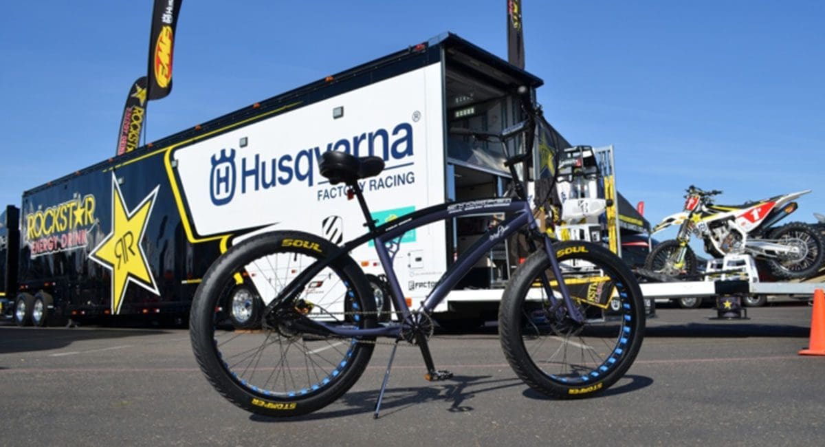 A Pedal Stomper bike is parked in front of a trailer.