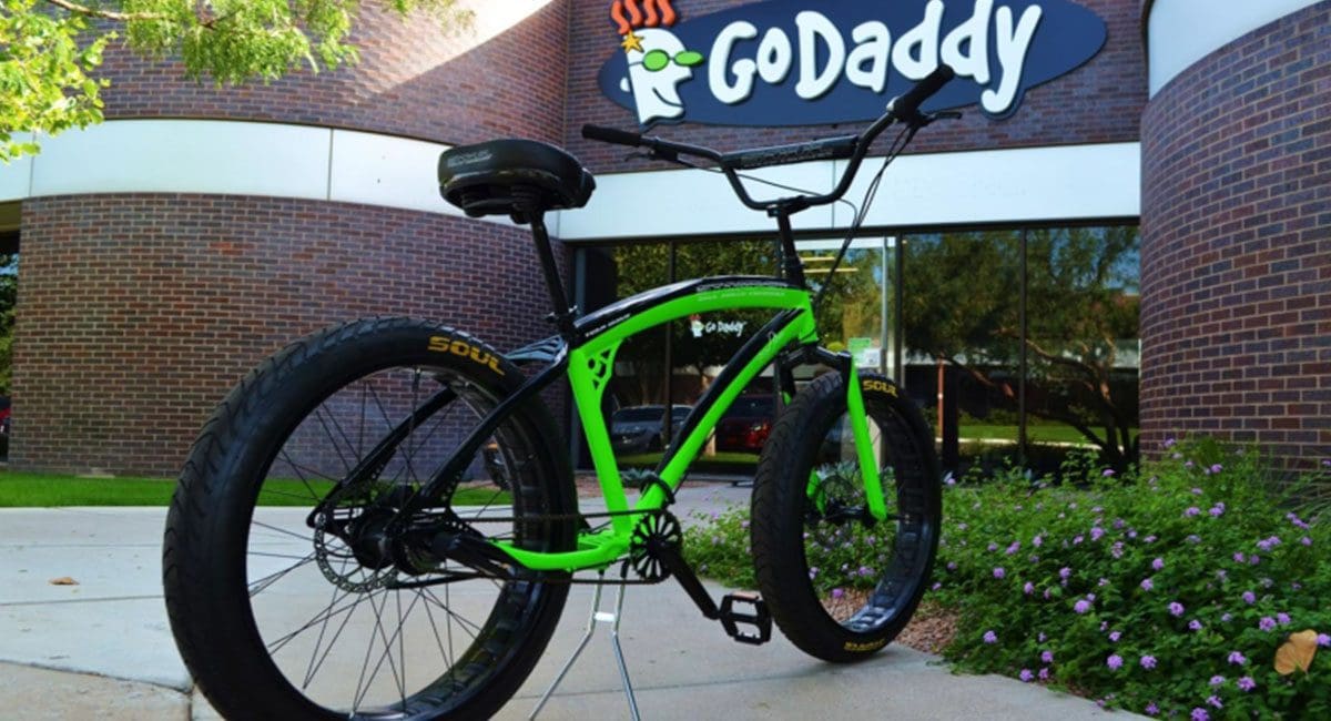 A green SOULFAST bike parked in front of a building.