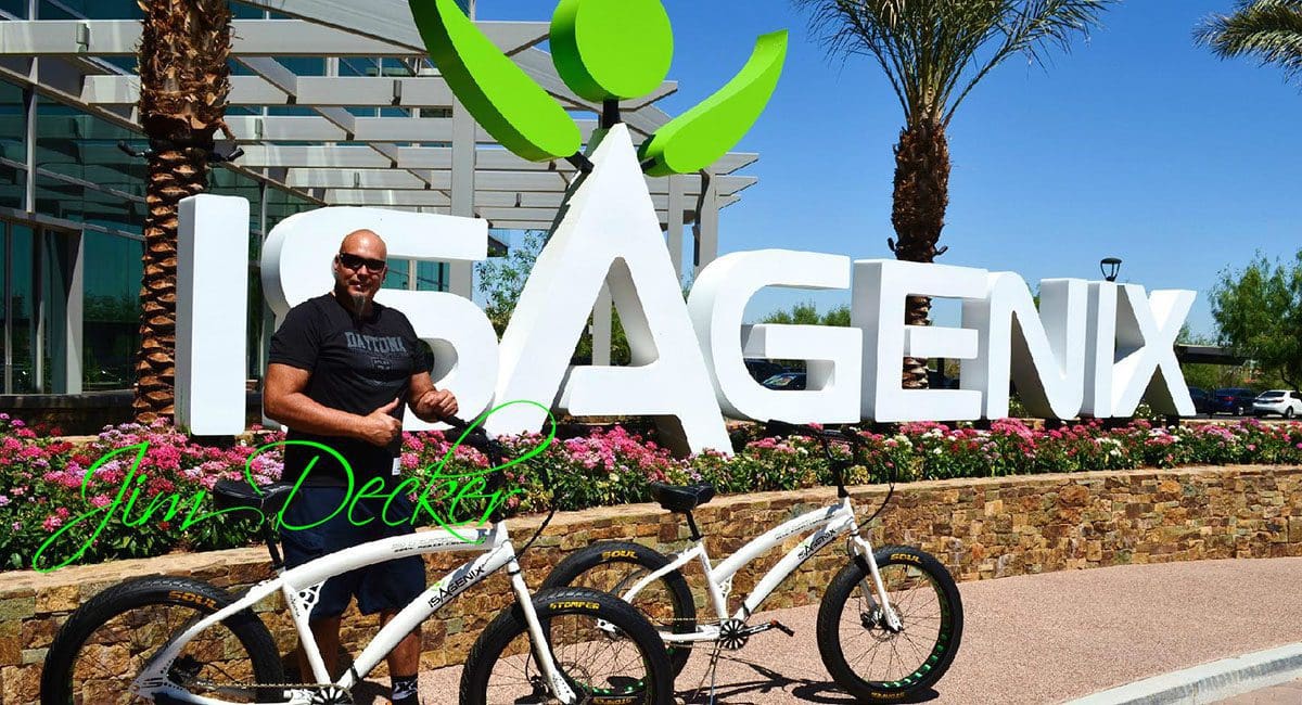 A man standing in front of a sign that says isagenx, showcasing the SOULFAST EBIKES.