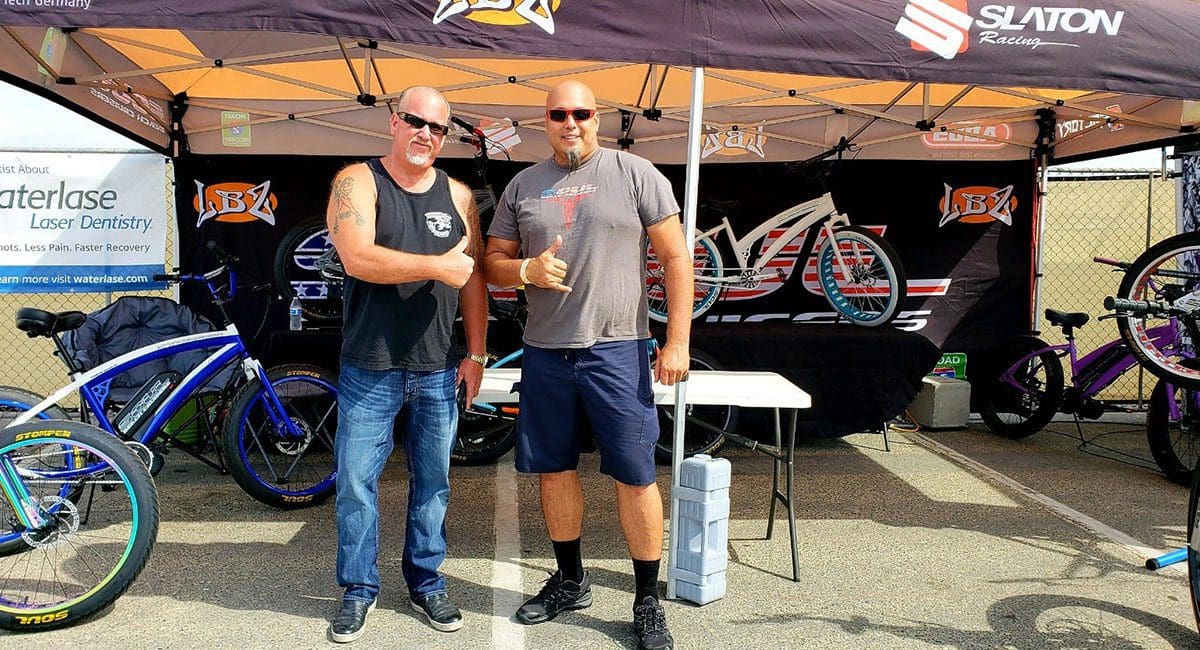 Two men standing in front of a tent with Soulfast eBikes.