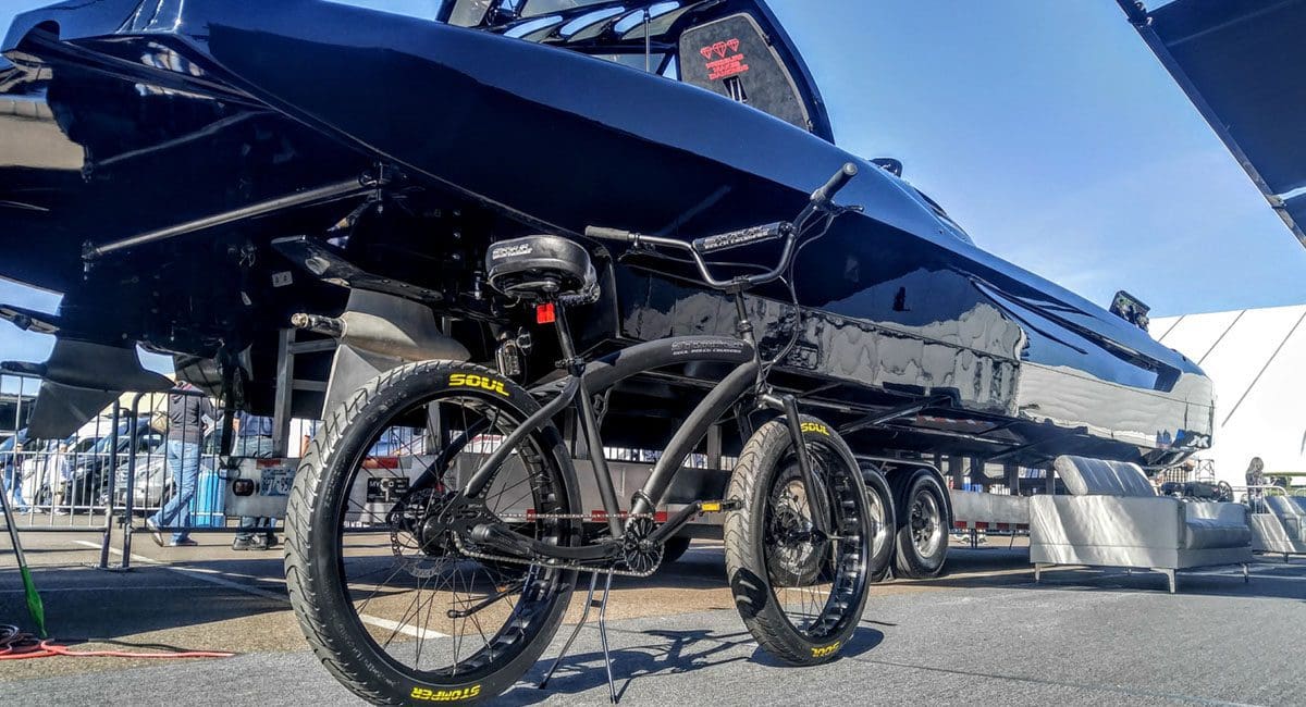 An Ebike is parked in front of a boat.