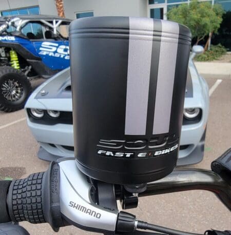 A motorcycle with a Soul Embossed Cup Holder - Black attached to the handlebars.