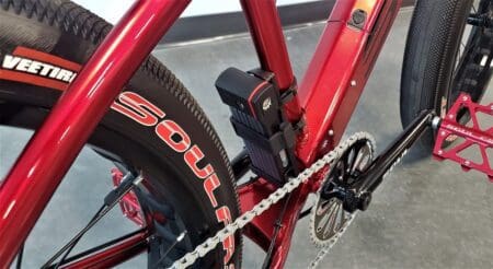 A close up of a red bicycle with an ABUS Bordo 5700K Lock attached.
