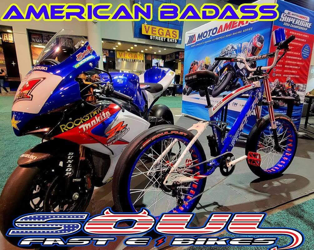 Motorcycle and bicycle on display indoors.