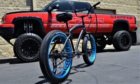 A Soul Stomper Black Ops Code Blue parked in front of a truck.