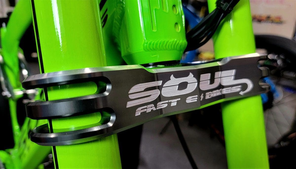 A close up of the side of a green bicycle.