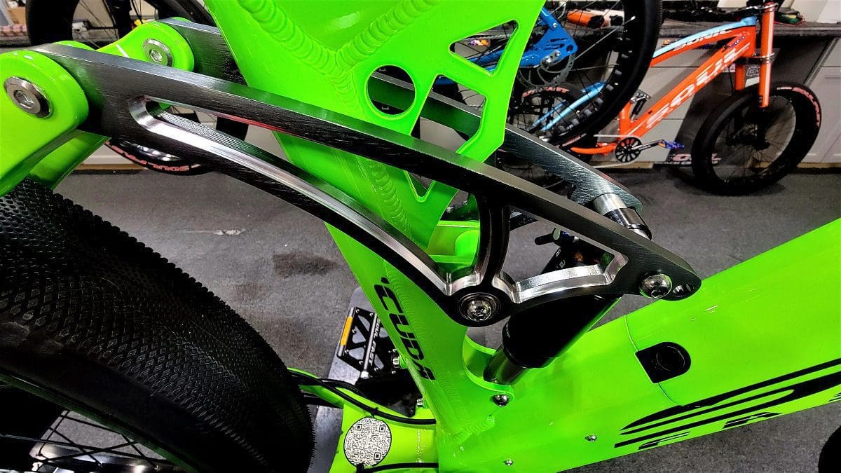 A close up of the front wheel on a green bike.