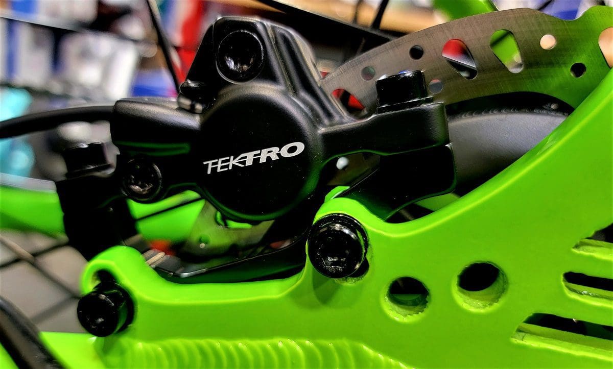 A close up of the brake and caliper on a bike