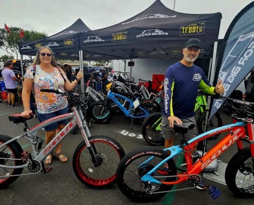 A couple of people standing next to some bikes.