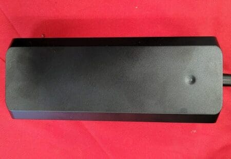 A black box sitting on top of a red table.