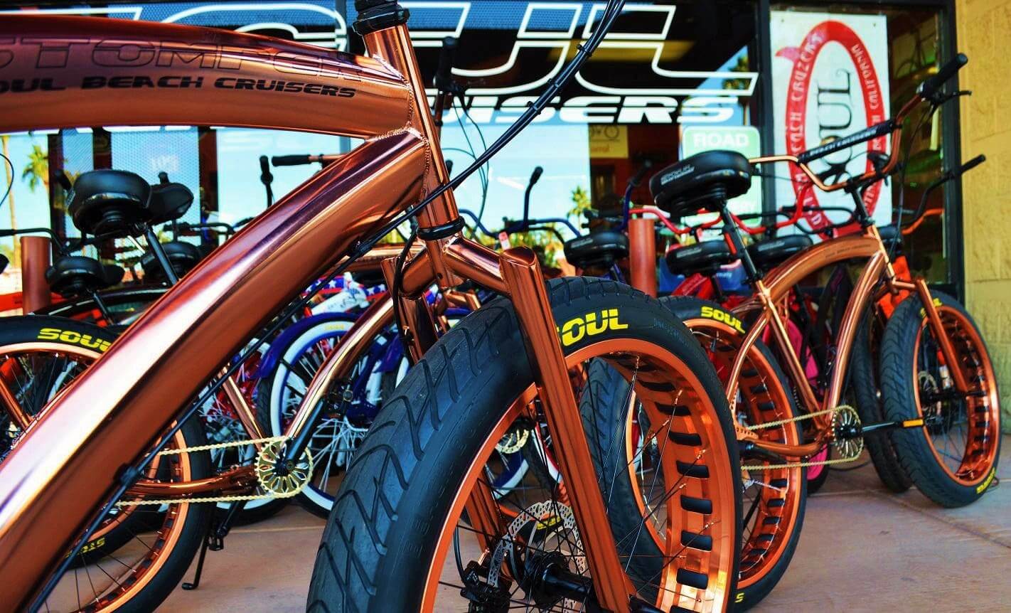 A group of Soul Stomper Copper bikes parked in front of a store.