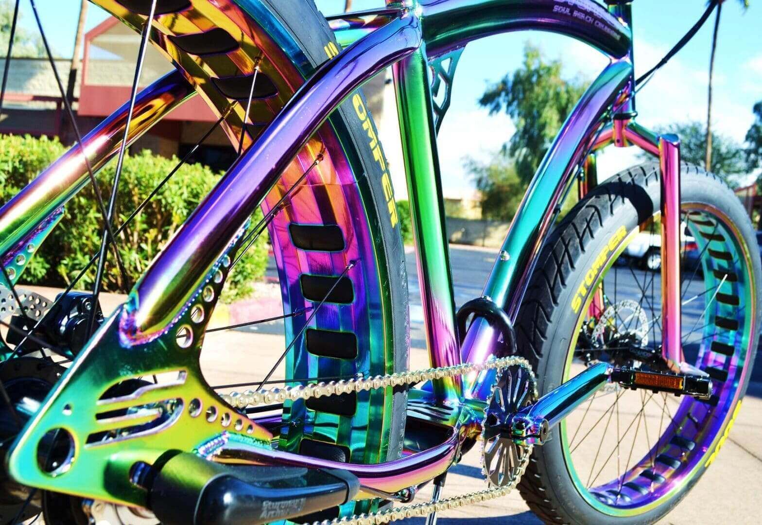 A Soul Stomper Oil Slick colored bicycle parked on the side of the road.