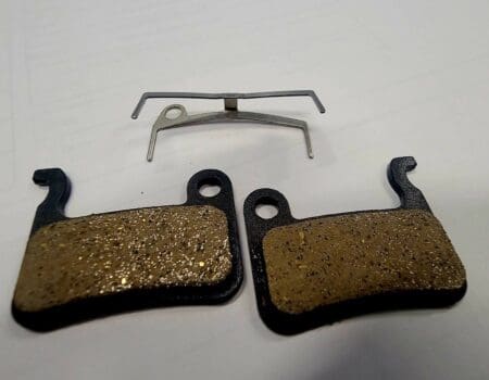 A pair of brake pads and one is broken.