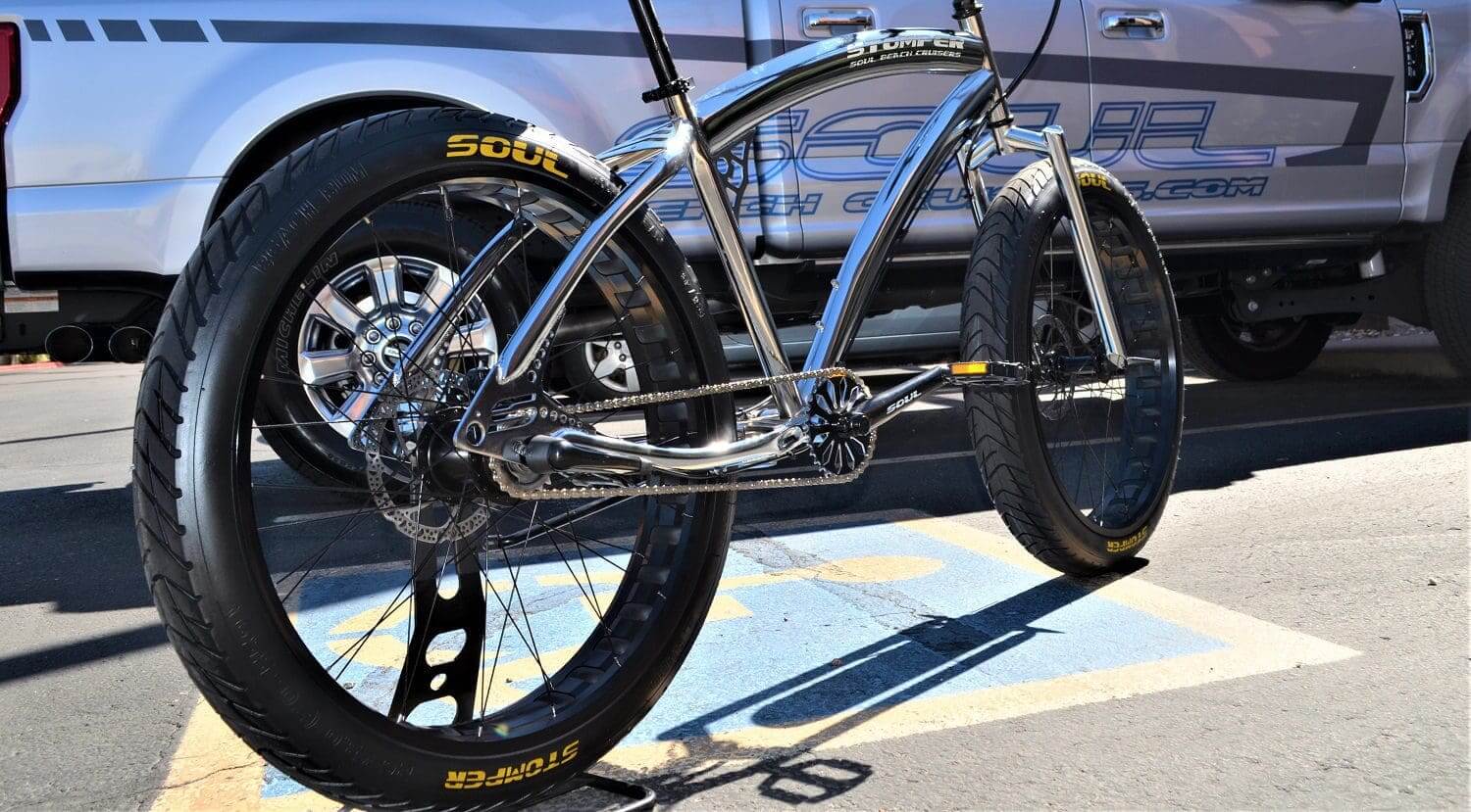 A bike is parked in front of a truck.