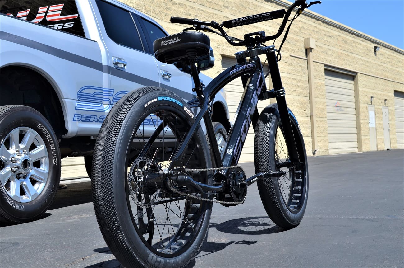 Bicycle with fat tires beside a truck.