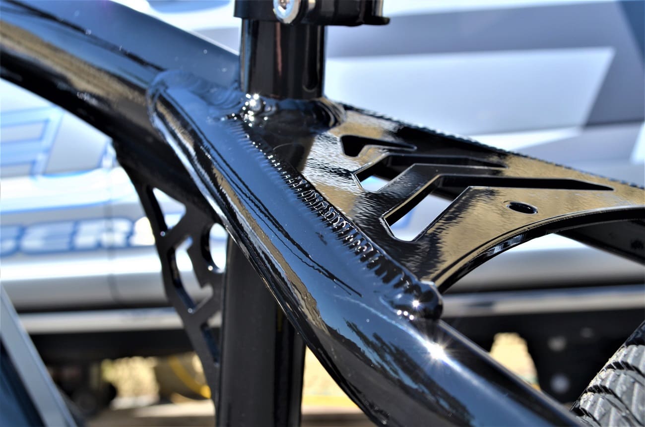 Shiny black bicycle frame close-up.