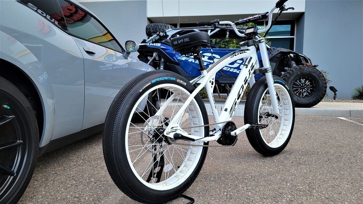 A bicycle parked next to a car on the street.