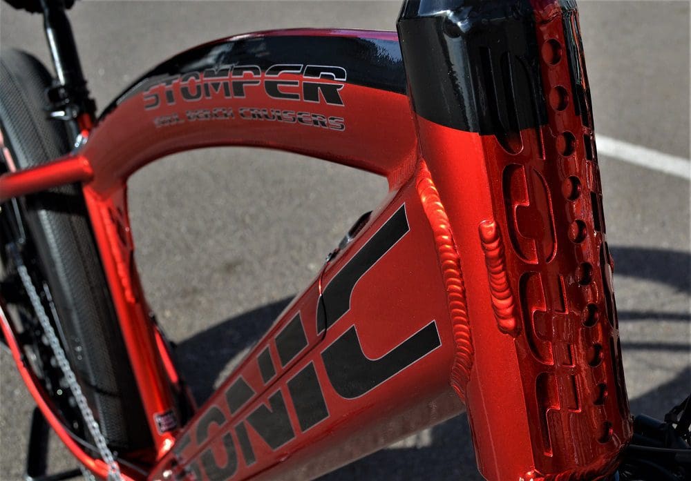 A close up of the side of a red bicycle.