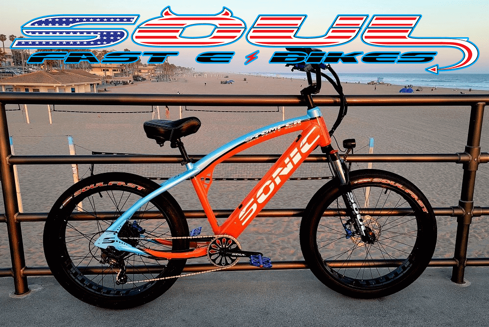 A blue and orange bike parked on the side of a road.