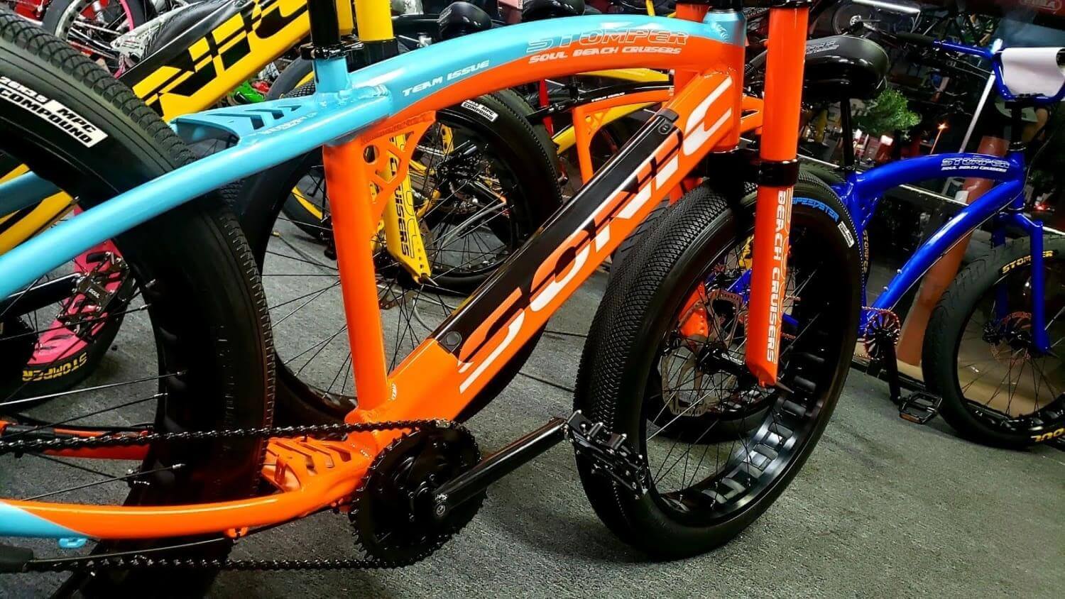 Colorful bicycles displayed in a row indoors.