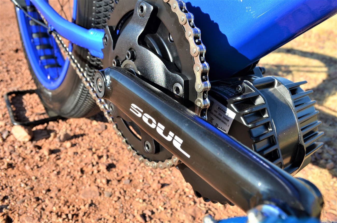 Blue bicycle with visible chain and motor.