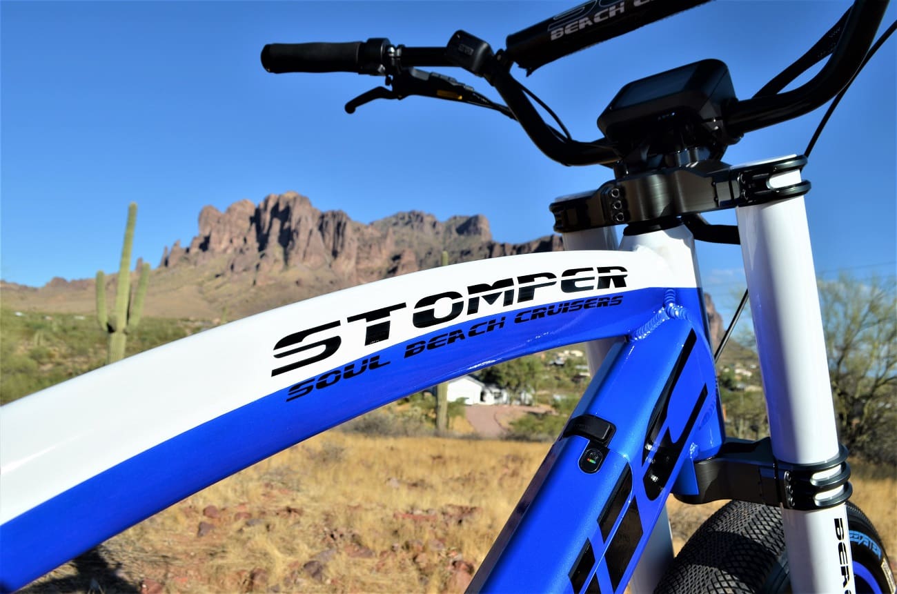 Blue and white bicycle with mountain background.
