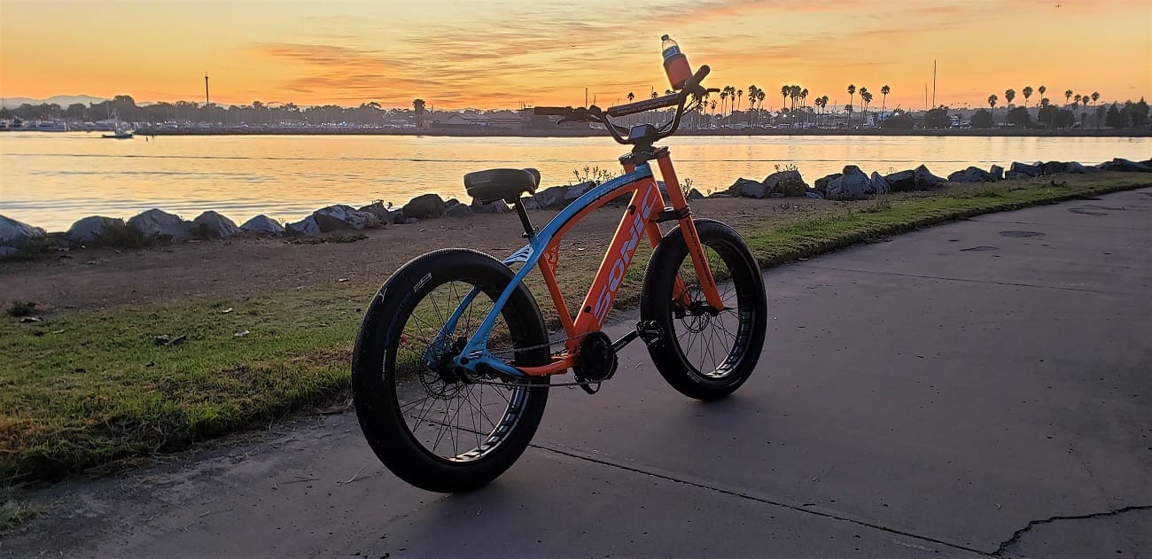 Bicycle by lakeside at sunset.
