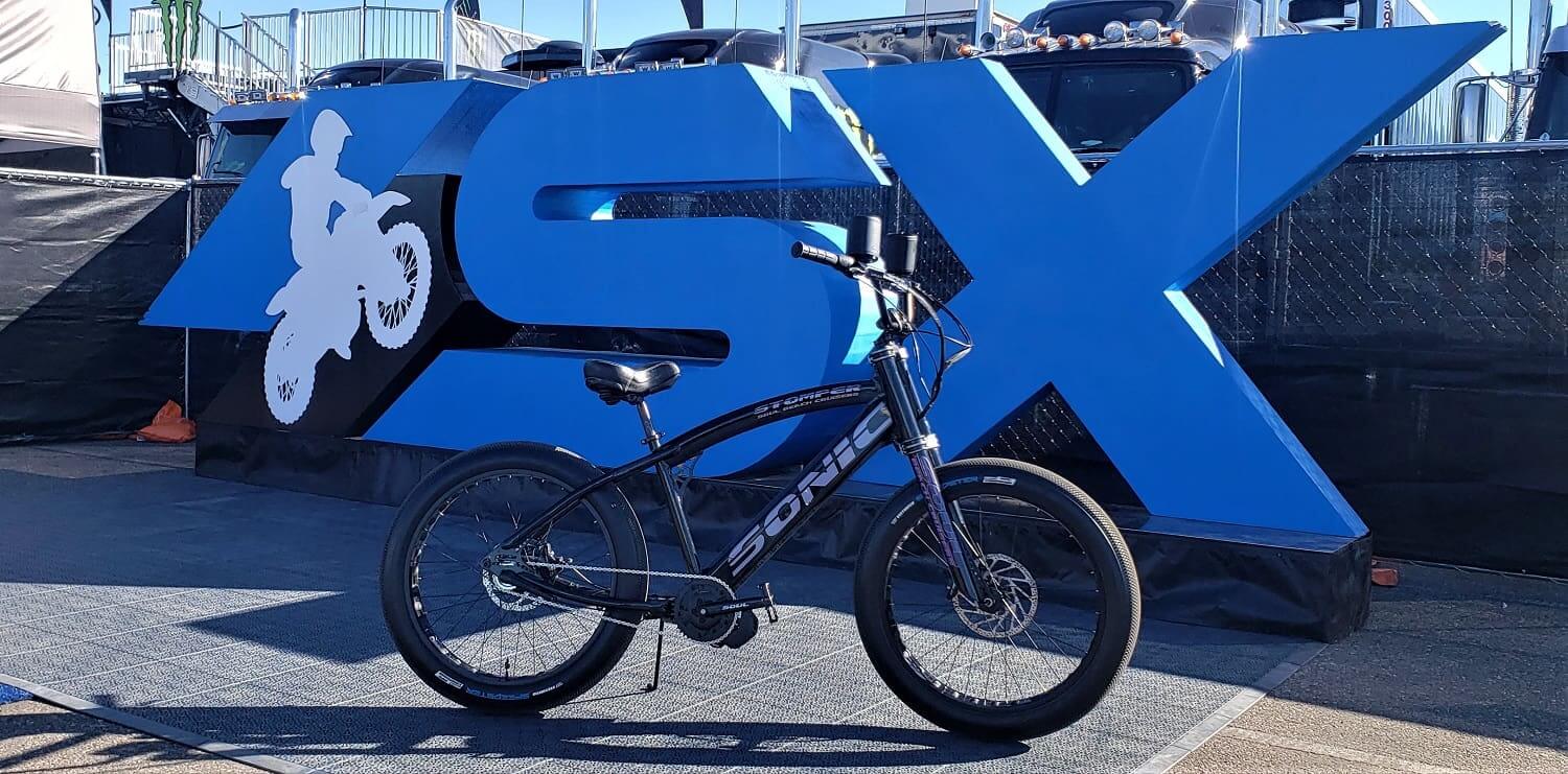 Bicycle in front of large SX sign.