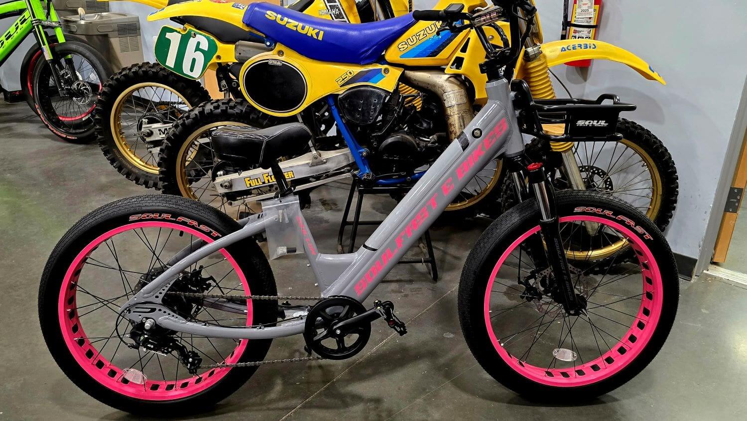 Gray electric bike with pink wheel rims.