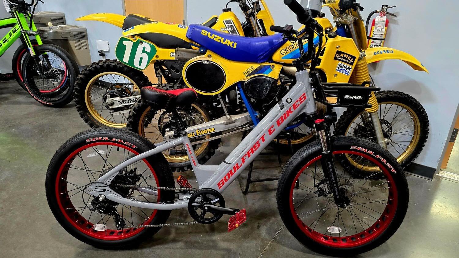 Motorcycles and bicycle displayed in showroom.