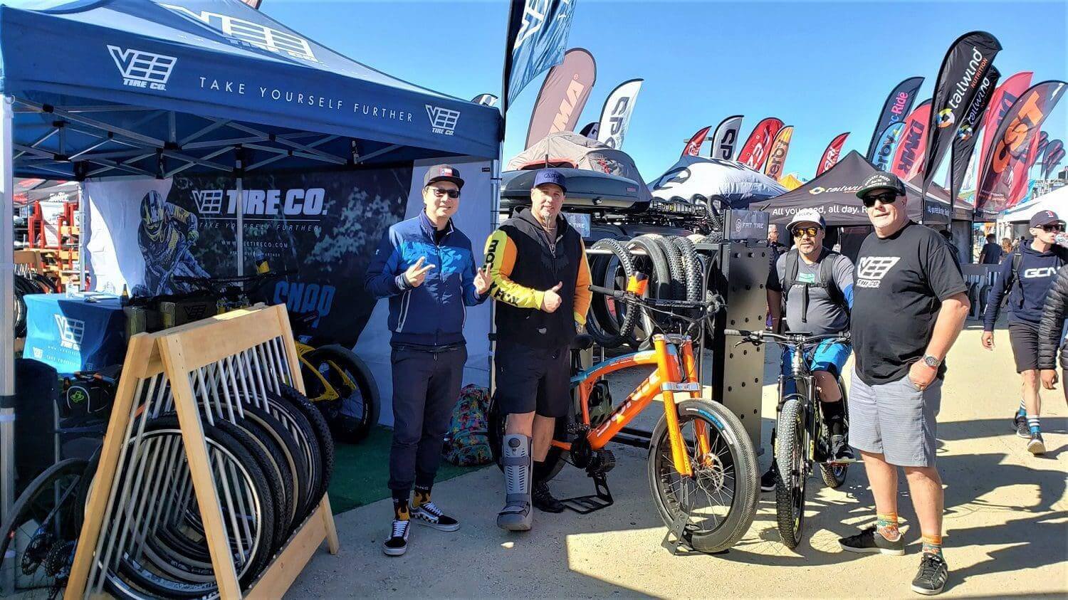 A group of people standing around a bike shop.