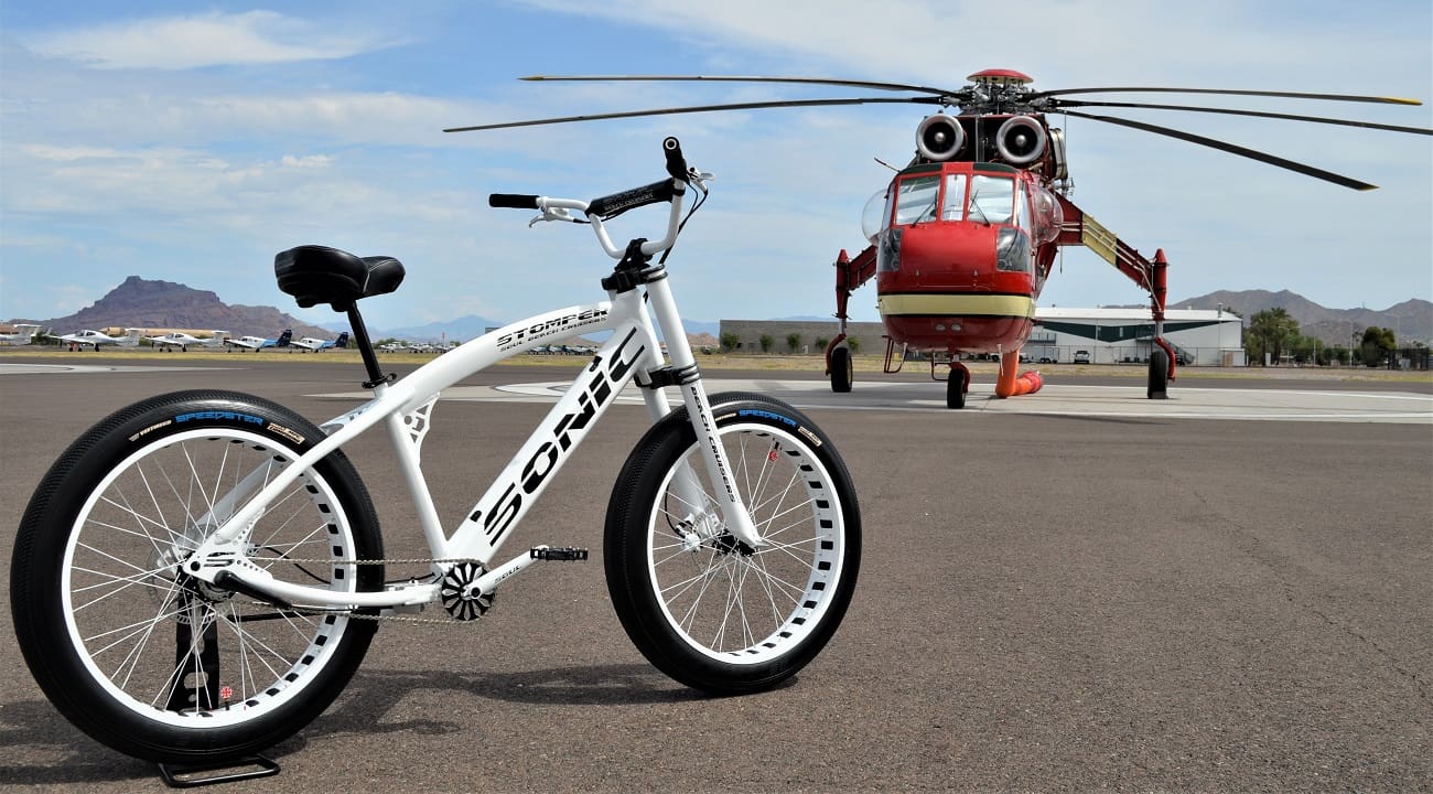 Bicycle and helicopter on airport runway.