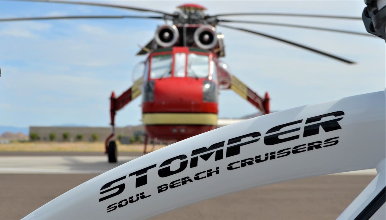 Bicycle frame and helicopter on airstrip.