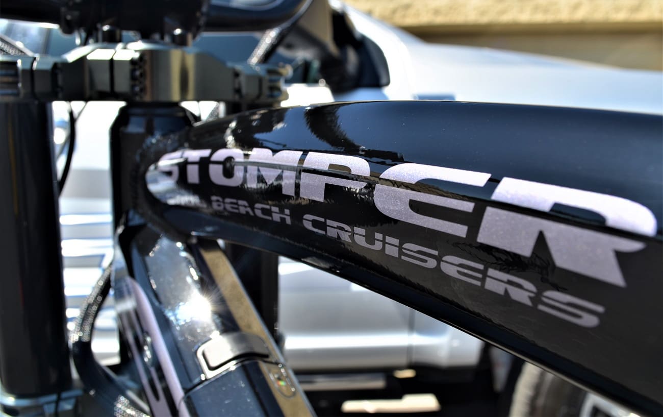 Close-up of black bicycle frame with logo.