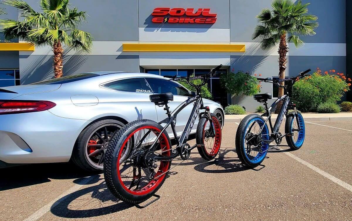 Car and bikes parked outside store.