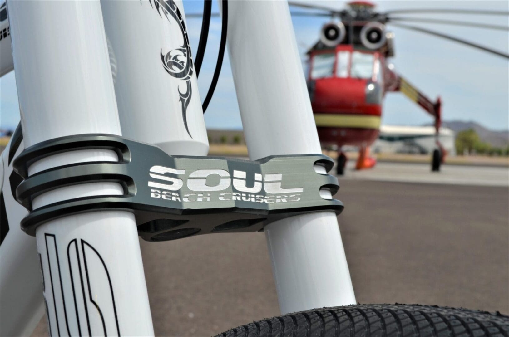 Bicycle front with helicopter in background.