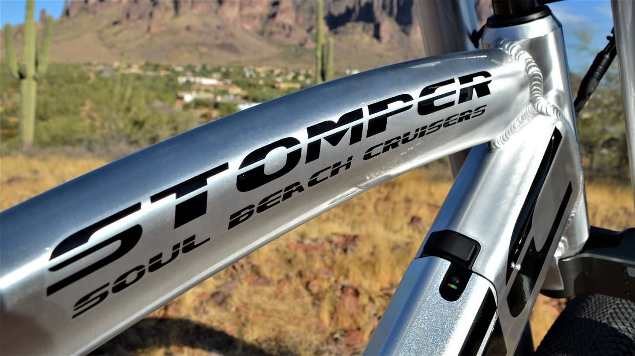 Silver bike frame with "Stomper" text outdoors.