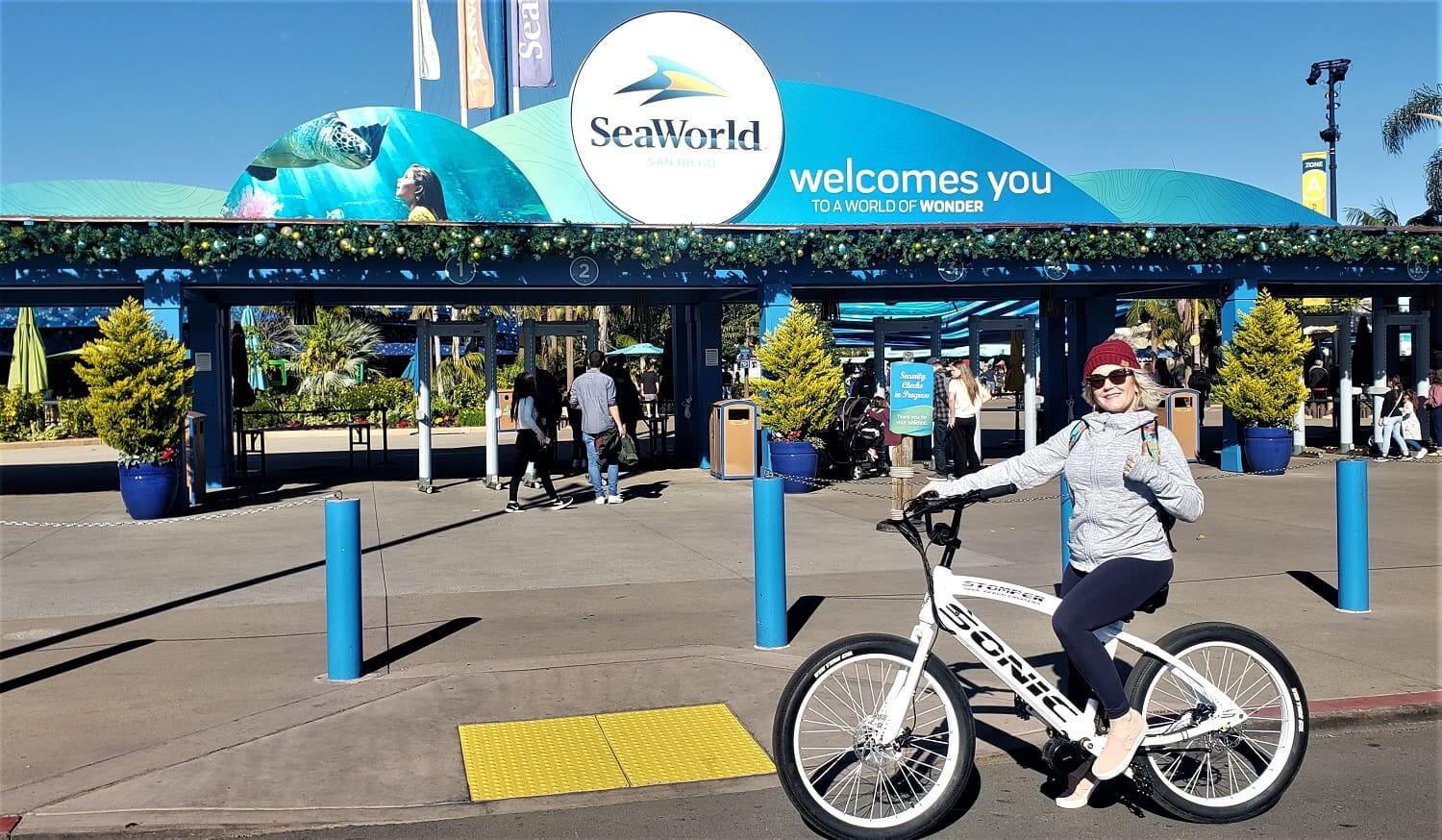 Person on bicycle in front of SeaWorld.