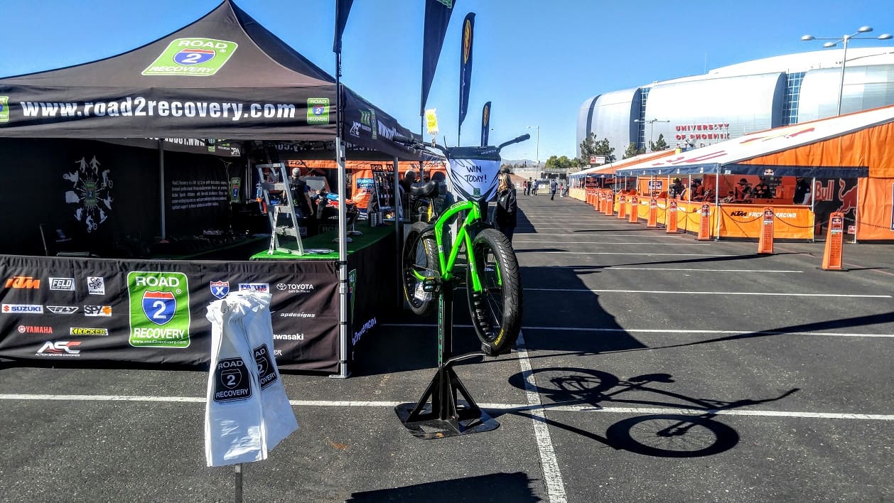 Outdoor bike event with tents and displays.