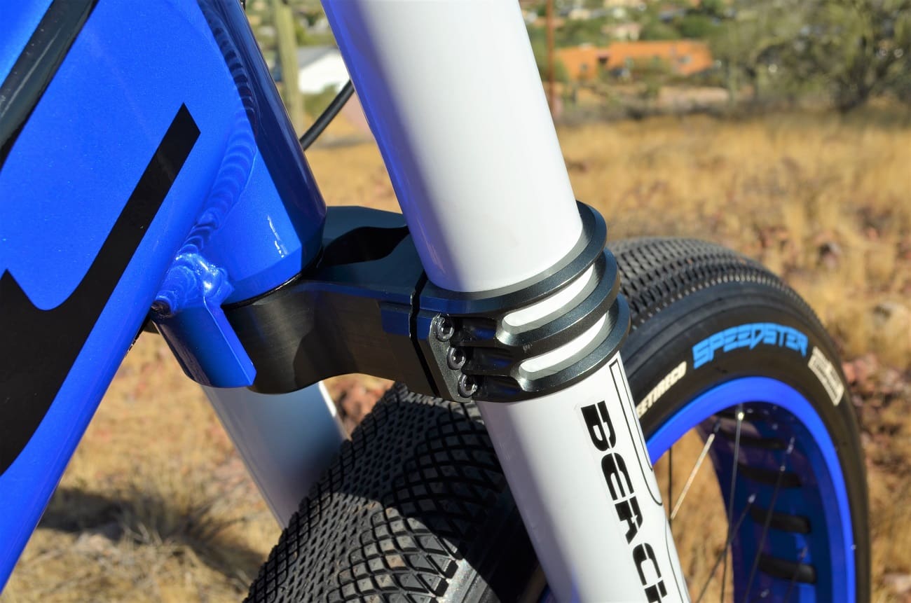 Close-up of blue bicycle front suspension.