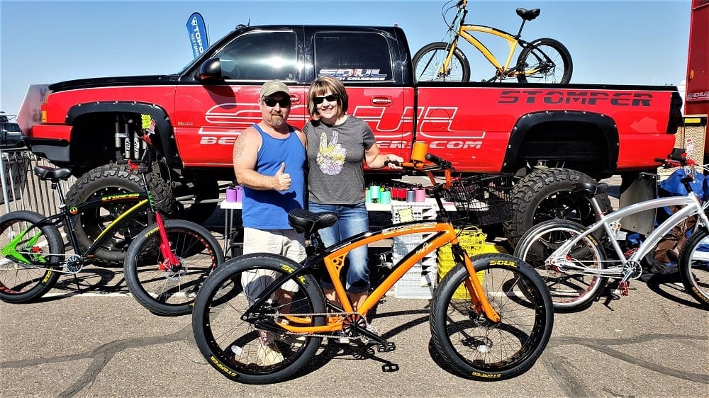 People posing with bicycles and truck.