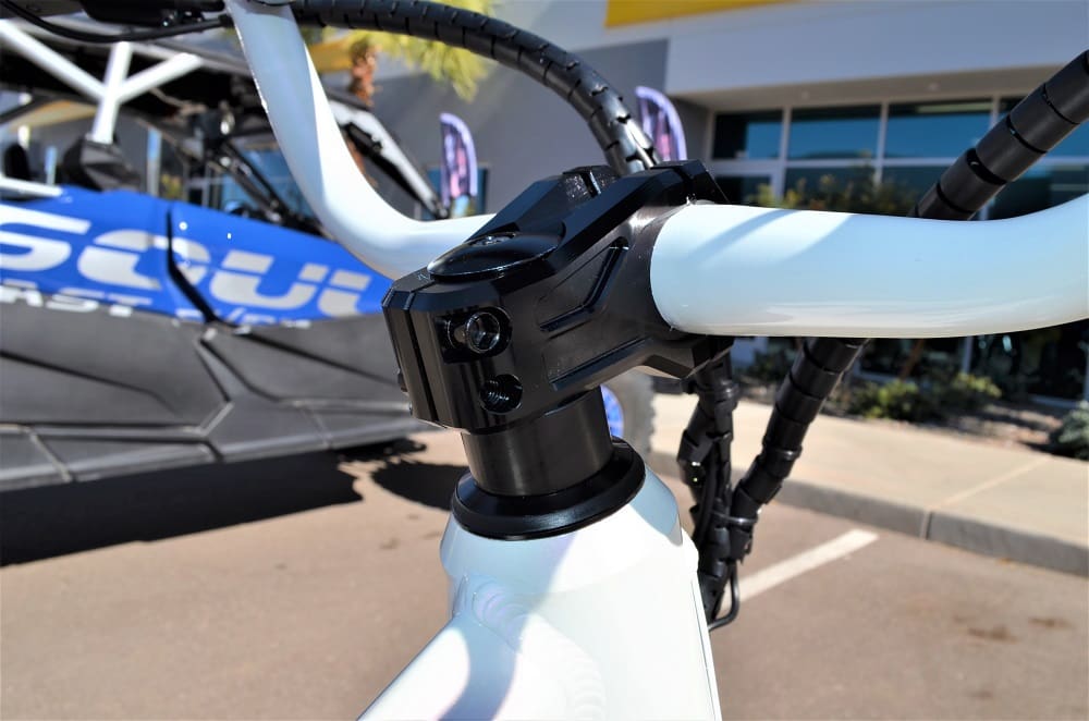 Close-up of bicycle handlebars and stem outdoors.