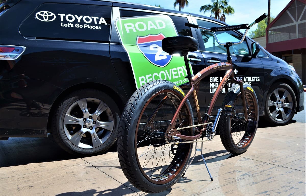 Bicycle parked in front of Toyota van.
