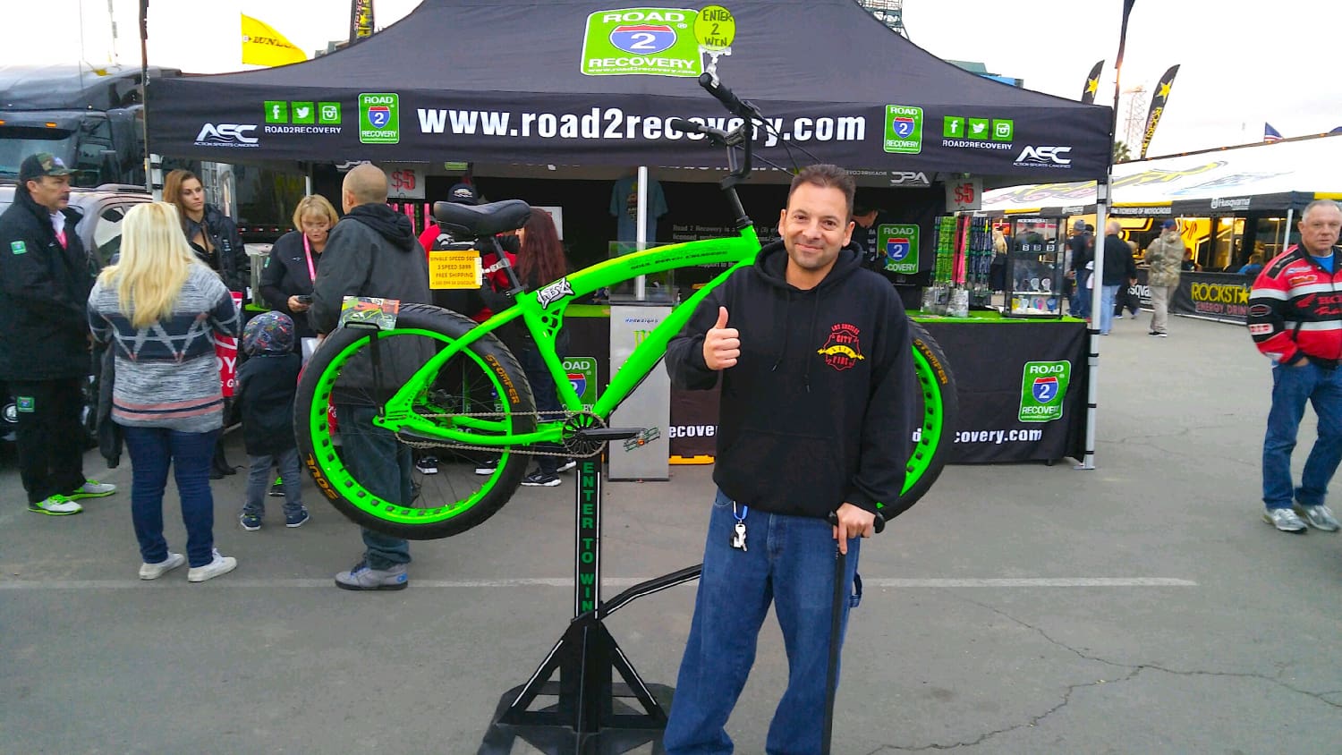 Man poses with bright green bicycle.