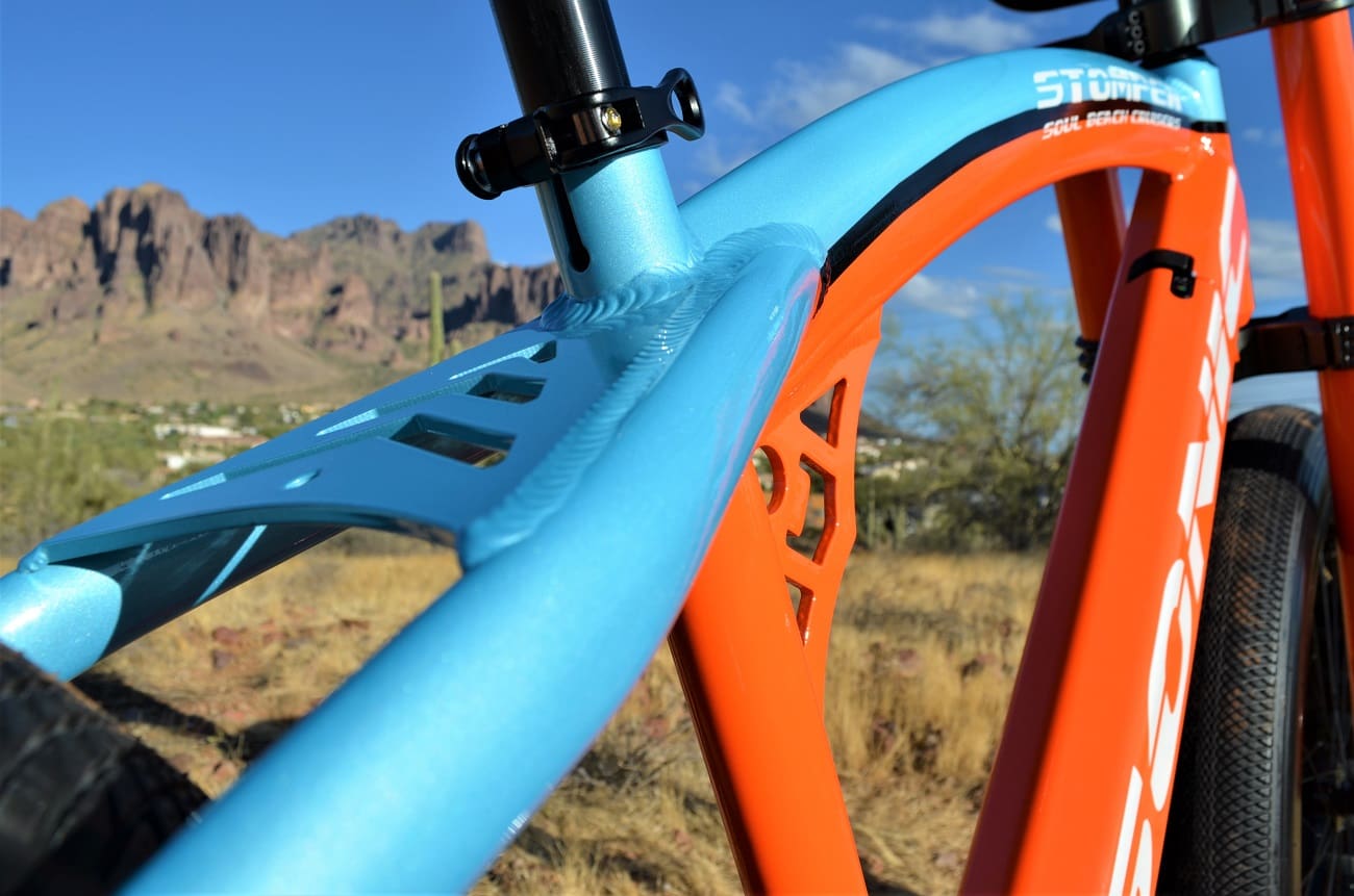 Close-up of colorful bike frame outdoors.