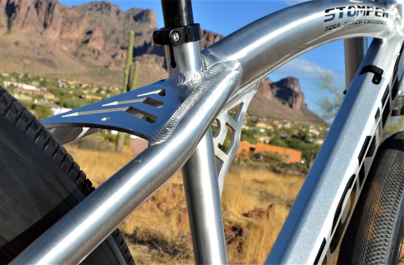 Silver bike frame with desert mountain backdrop.