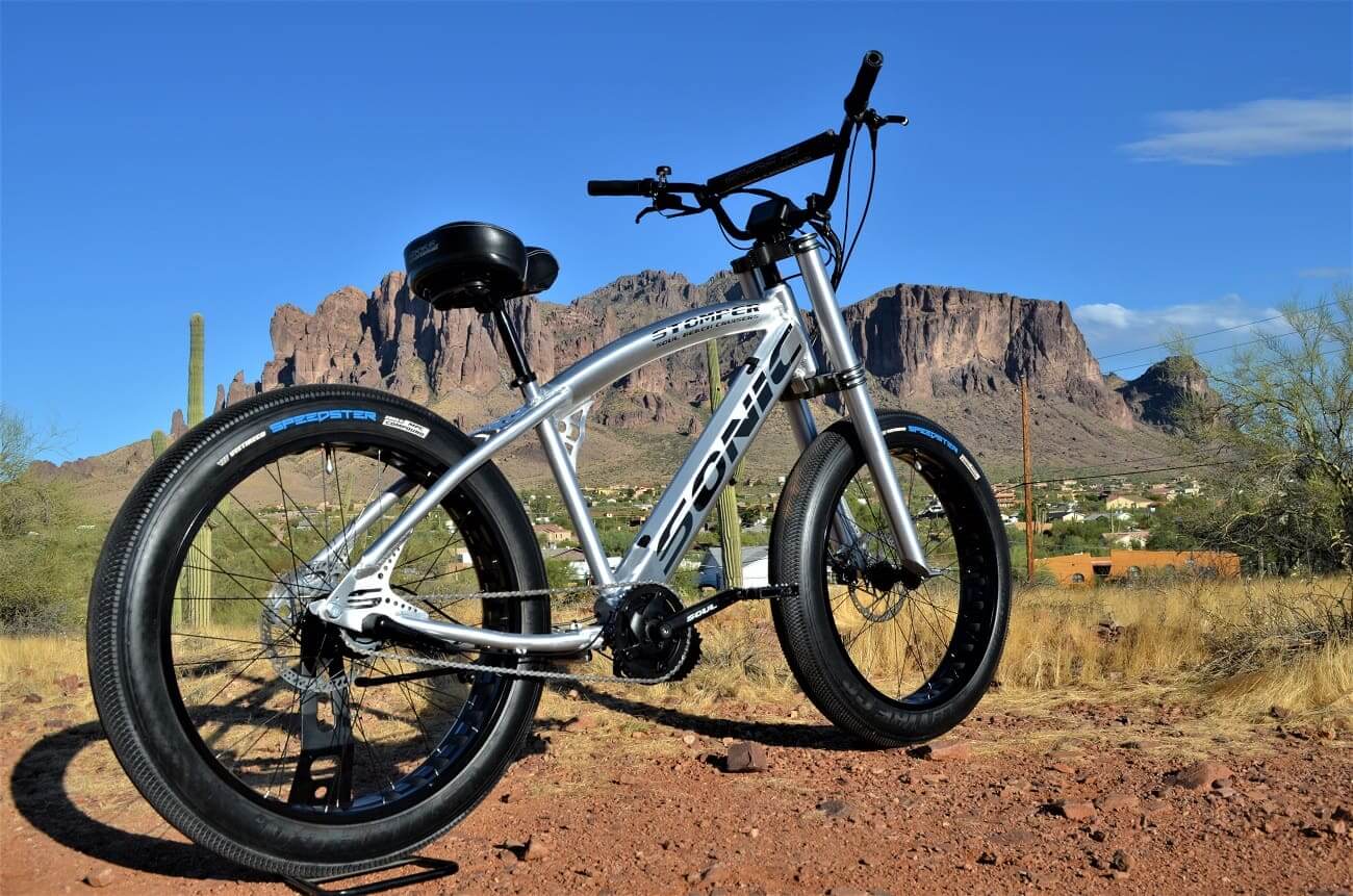 Silver bicycle with mountainous desert background.