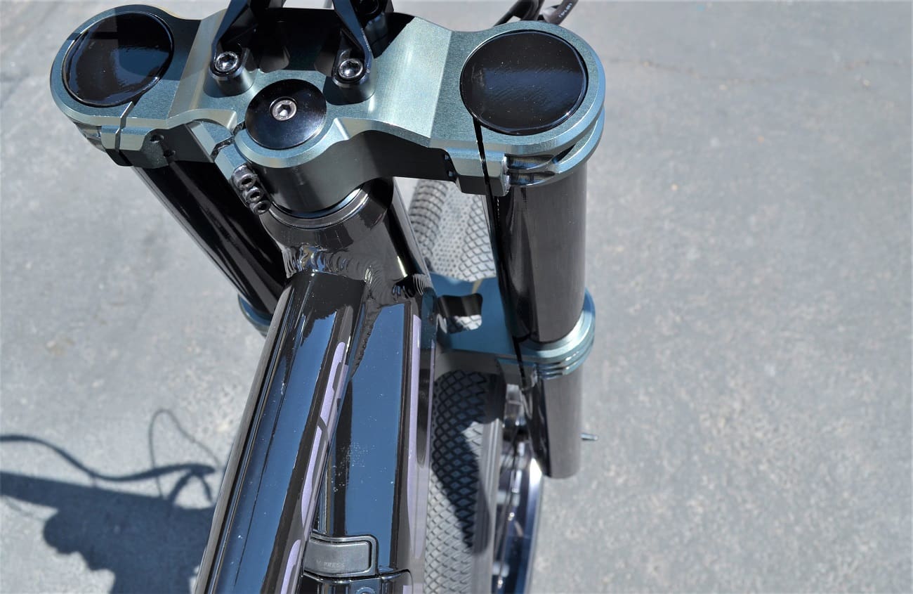 Close-up of motorcycle front suspension system.
